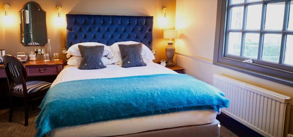 The Fleece At Cirencester Εξωτερικό φωτογραφία A bed with a blue throw